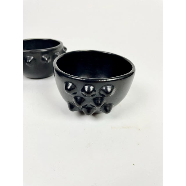 A pair of wonderfully sculptural bowls sculpted and then burnished from the special black clay coming from the state of...