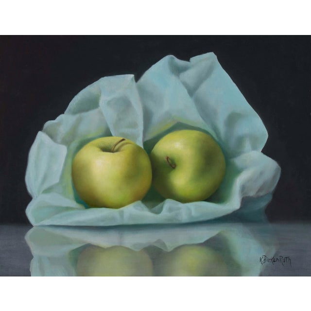 Burrowed in Blue by Kelly Birkenruth | Oil On Panel Still life of green apples on blue fabric For Sale