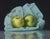 Burrowed in Blue by Kelly Birkenruth | Oil On Panel Still life of green apples on blue fabric For Sale
