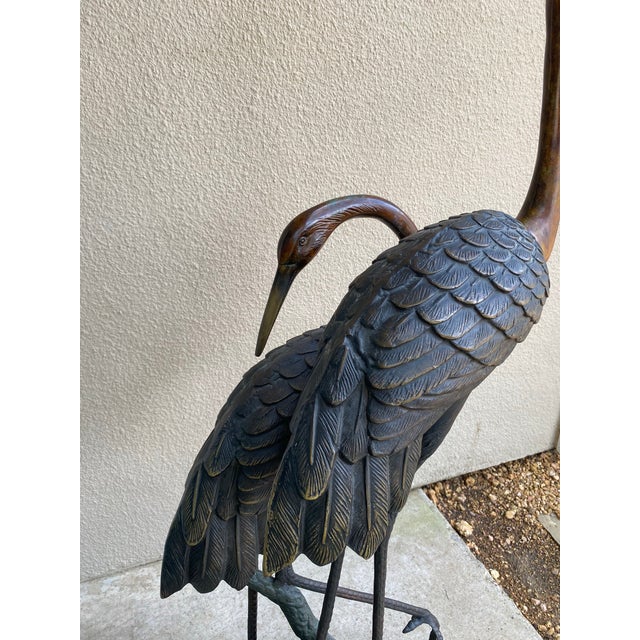 Tall cast bronze cranes with wooden base…a beautiful sculpture for interior or exterior. In Asian culture, cranes...