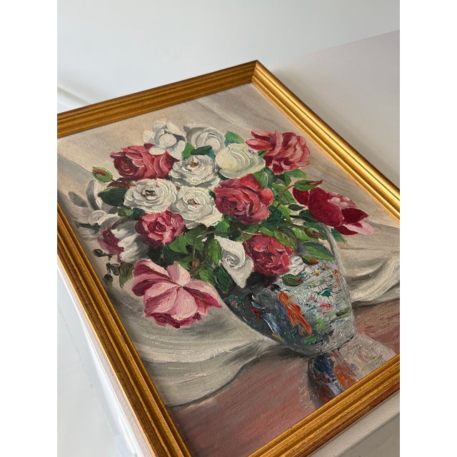 Mid-century European oil on board still life featuring a bouquet of roses arranged in a porcelain vase. Signed E....
