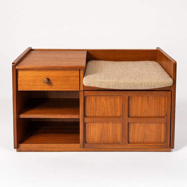 A beautifully designed mid-century teak telephone bench by Nathan Furniture, combining elegant form with practical...