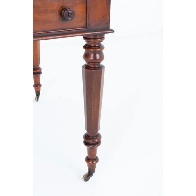 French mahogany side table which can also function as a desk Circa 1880 This elegant side table stands upon shaped legs...