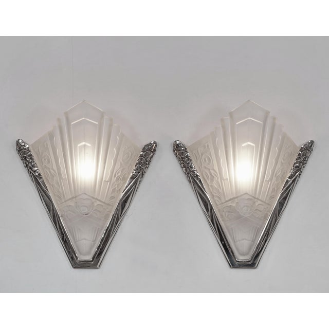 SEVB A pair of large art deco wall sconces made in France around 1930. Nickel plated bronze or solid brass mounts hold...