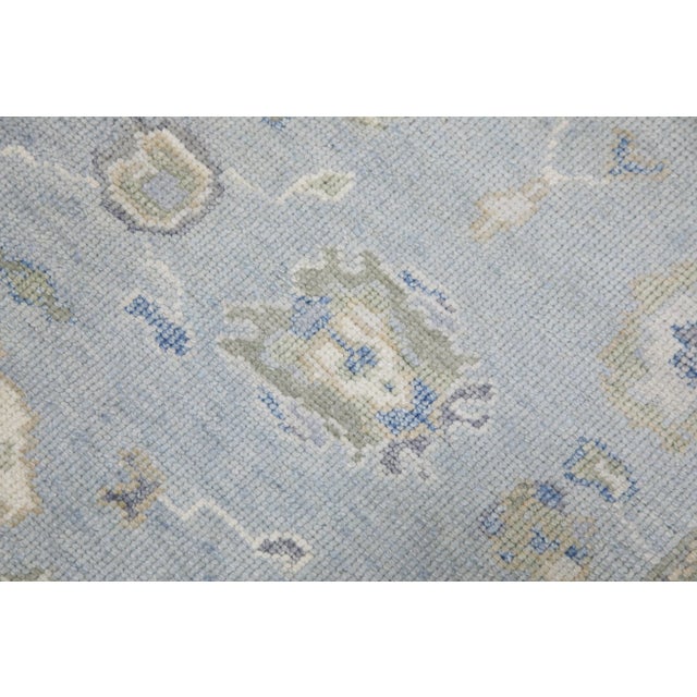 This modern Turkish Oushak rug is a stunning piece of art that has been handwoven using traditional techniques by skilled...