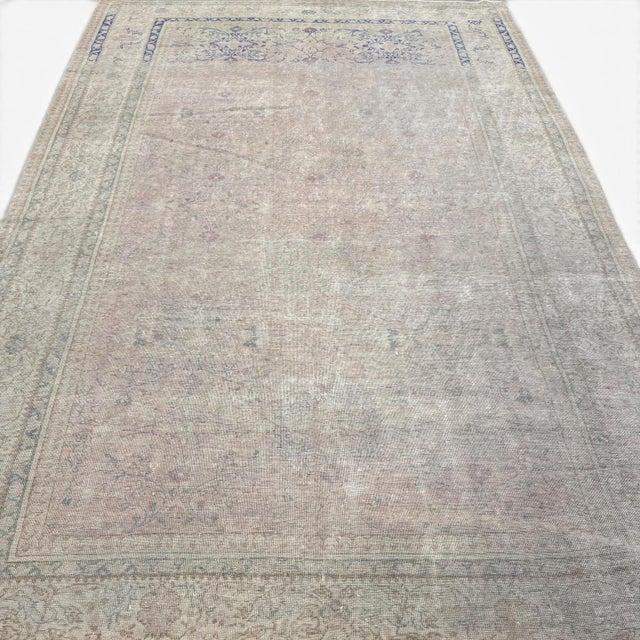This antique washed vintage rug from Sivas, Turkey offers a beautifully understated aesthetic, defined by its fine allover...