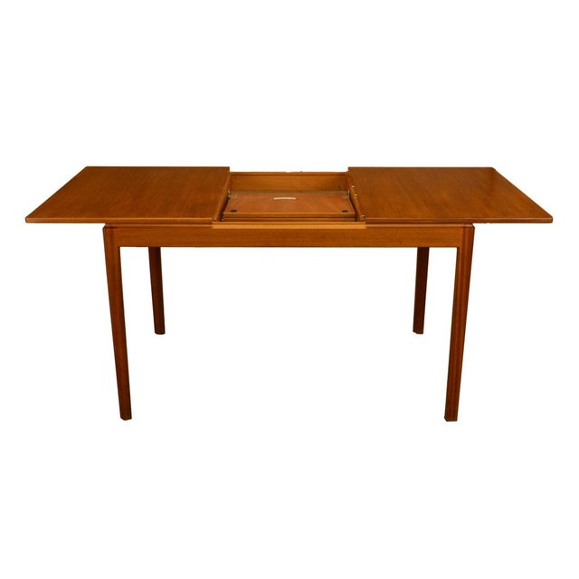 A very fine Mid Century Modern Danish style Teak extending dining table with a butterfly leaf by A.H. MacIntosh, Scotland...