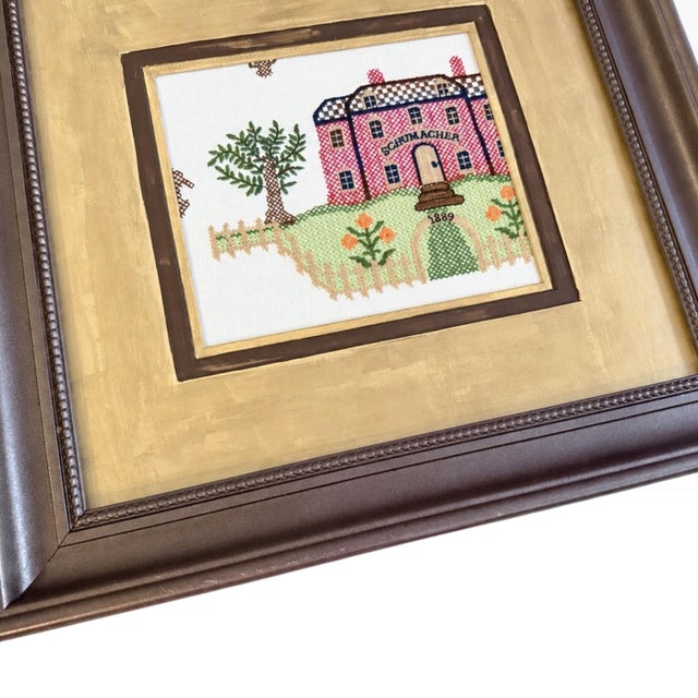 A charming, one-of-a-kind piece of upcycled wall décor featuring Schumacher’s embroidered Merrified Sampler textile. The...