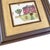 A charming, one-of-a-kind piece of upcycled wall décor featuring Schumacher’s embroidered Merrified Sampler textile. The...