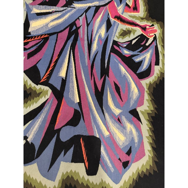 Handwoven wool tapestry depicting a stylized female figure in motion, rendered in a bold Cubist and Art Deco-inspired...
