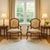 A pair of Louis XV-style armchairs with carved wood frames, cabriole legs, and tapestry-style upholstery in warm neutral...