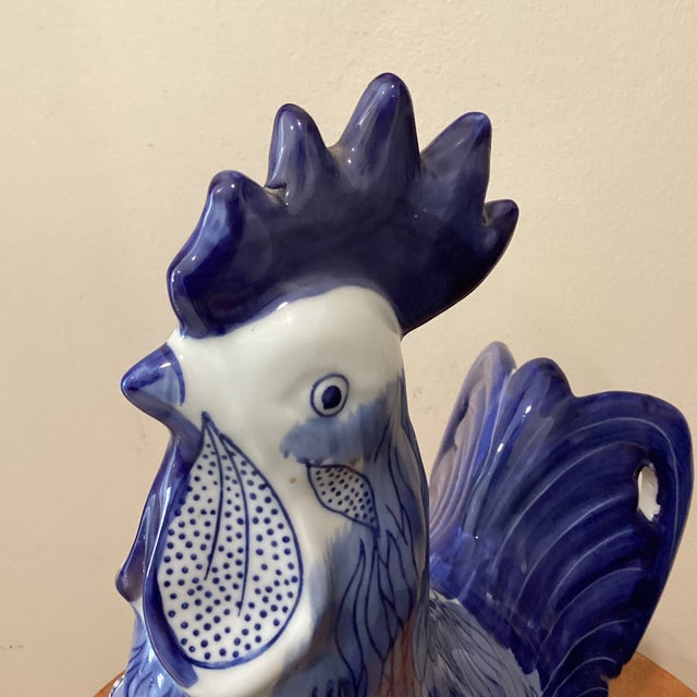 This vintage large hand-painted ceramic rooster sculpture in white and blue colors is a unique and charming piece for any...
