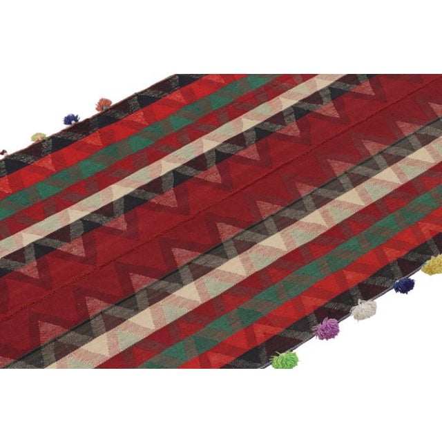 This vintage 5x8 Persian tribal kilim is handwoven in wool, and originates circa 1950-1960. This design remarks the panel-...