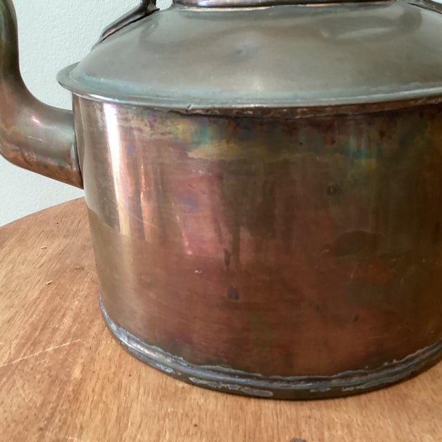 This early 19th century collectible hand-hammered English copper and brass tea kettle showcases the craftsmanship and...