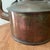 This early 19th century collectible hand-hammered English copper and brass tea kettle showcases the craftsmanship and...