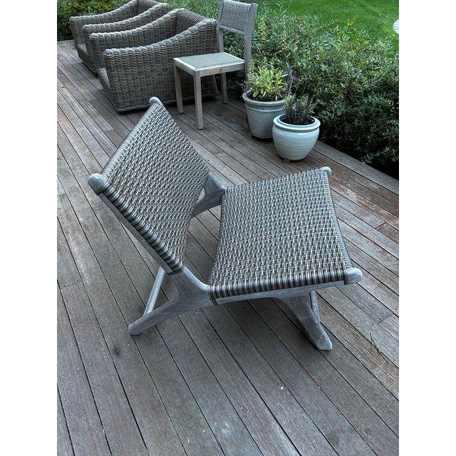 A single Arden Adirondack chair from CO9 Design, crafted from natural teak with a woven grey synthetic wicker seat and...