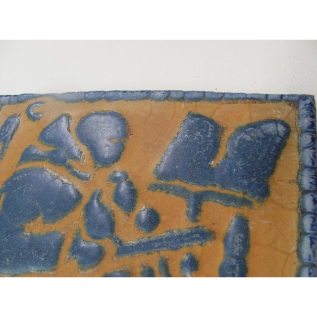 Rare, rare, rare. Grueby 6" x 6" x 3/4" figural tile depicting a blue segmented fiddler on a mustard yellow background....