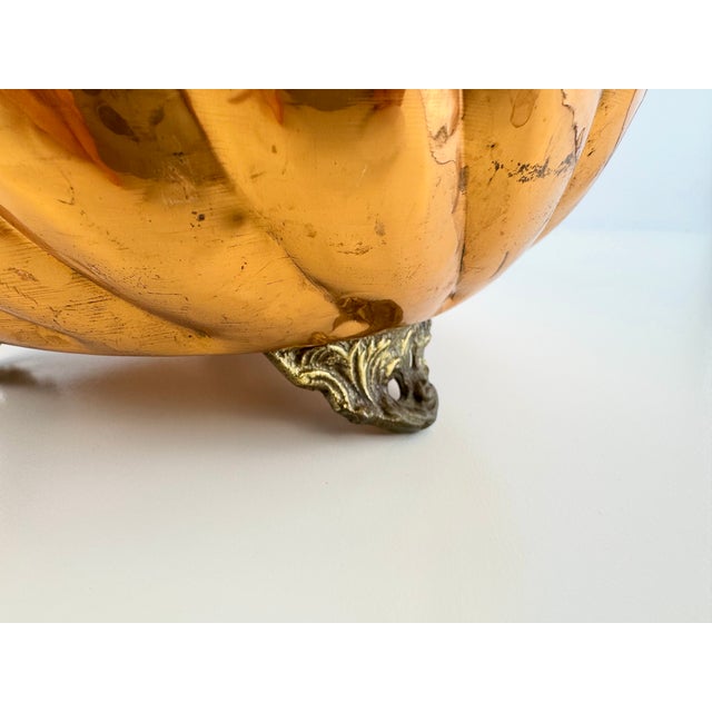 A striking vintage copper planter featuring a deeply fluted body, scalloped rim, and warm aged finish. The hammered copper...