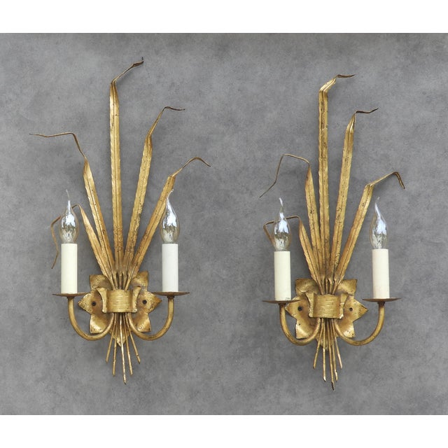 Exceptional Spanish gilt-tole wall sconces by Ferrocolor, dating to the 1950s. Executed in hand-worked gilt metal as...