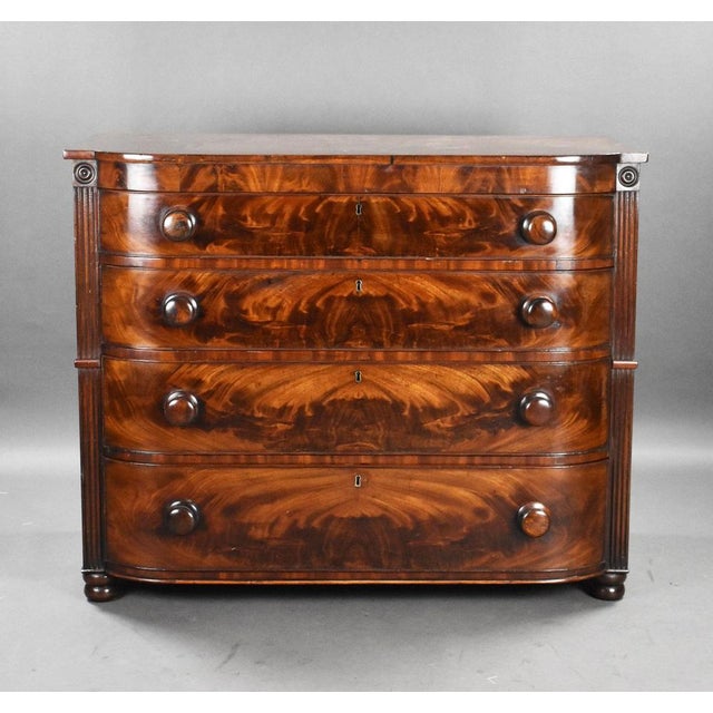 For sale is a good quality Victorian flame mahogany chest of drawers, with four graduated drawers, each with bun handles...