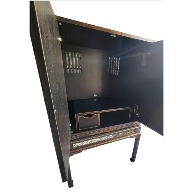 An incredible massive Chinoiserie hand painted pagoda garden scene black and bronze 2 piece storage/tv cabinet. This is an...