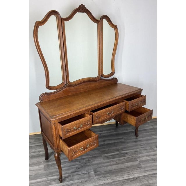 This Vintage French Louis–style dressing table presents elegant proportions and refined decorative detail, crafted in oak...