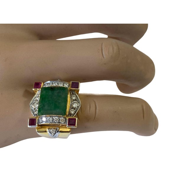 This exquisite Art Deco 22K Gold ring showcases a stunning jadeite jade center stone, four square ruby stones, and 18...