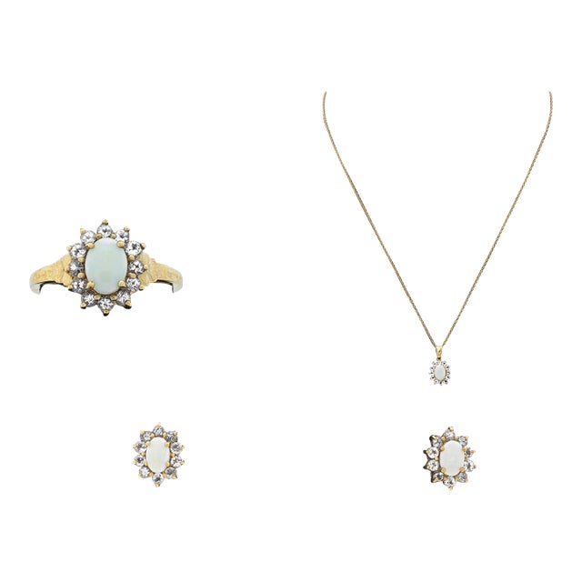Opal and Tanzanite 10K Yellow Gold Jewelry Set, including one ring adorned with one white opal cabochon weighing approx....
