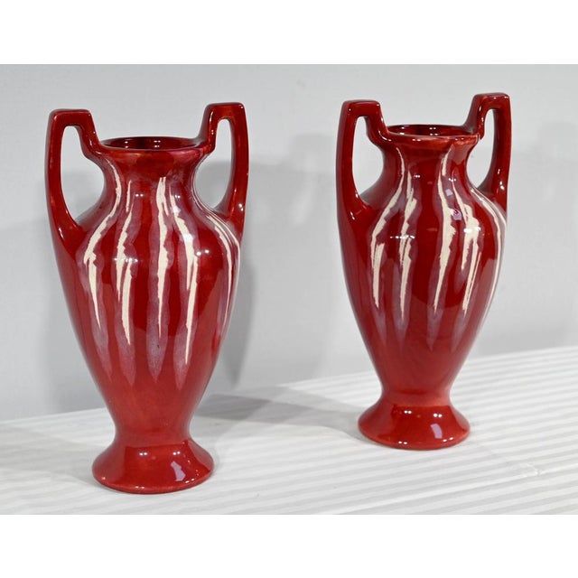 Pair of enameled ceramic vases, Art Nouveau style, flat seats and flared short passes. Ogival sides, in the bottom, have...