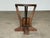 Striking primitive sculptural side table handcrafted from solid wood, likely mid-20th century. The piece features a richly...