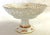 Pretty vintage compote dish made in Germany. The piece is made of white porcelain with a reticulated edge detail, and...