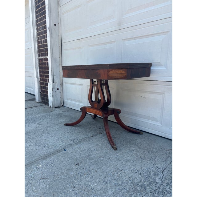 We have a beautiful Federal Revival revolving top table for sale. It features a classic lyre base, drop leaf design,...