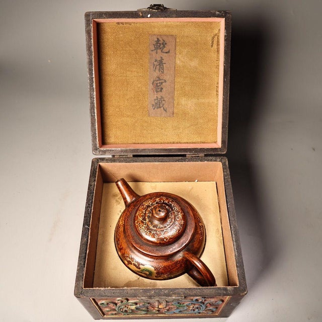This striking vintage teapot is crafted from Yixing zisha (purple clay), a traditional material prized for tea brewing....