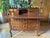 This mid-20th-century French Provincial secretary desk features a sloping drop-front that opens to reveal a writing...