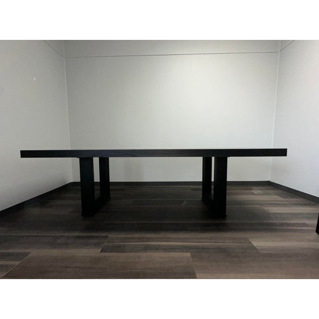 Part of the Michael Weiss collection, this dining table makes a striking statement with its double square cut-out pedestal...