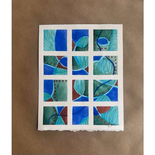 A vibrant geometric watercolor featuring twelve interconnected panels in rich cobalt blue, sea-glass green, and earthy...