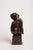 A contemporary figurative bronze of a seated woman, her form abstracted into long, fluid lines and resolved volumes. A...