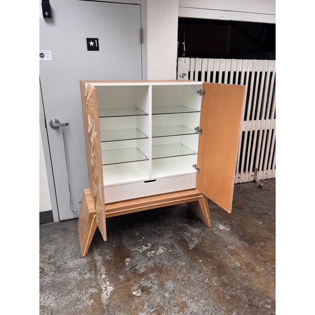Design Plus Gallery presents the Otto Bar from Jonathan Adler. This bar cabinet is made from wire-brushed and limed solid...