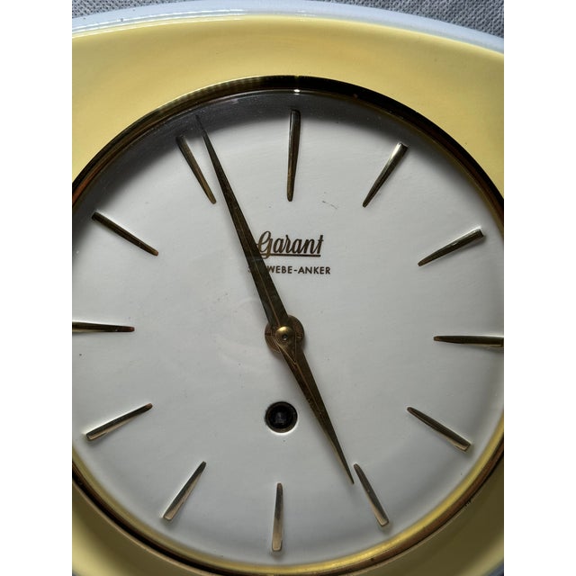 Ceramic wall clock by Garant from the mid 20th century. Classic mid-century modern design featuring yellow ceramic and...
