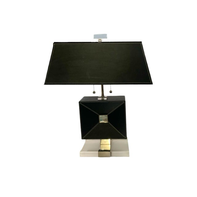 This pair of table lamps, featuring a black leather envelope design with an acrylic lucite base, is a stylish and modern...