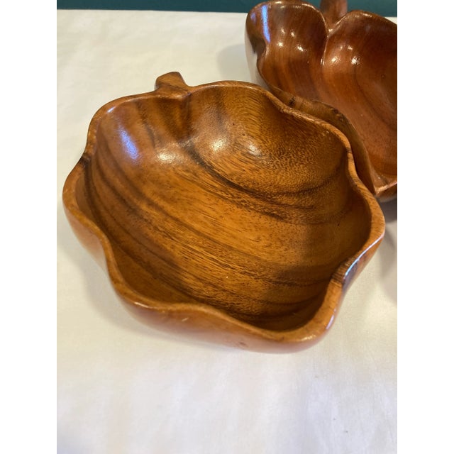 A beautiful set of three vintage monkey pod wood bowls featuring organic sculptural forms and richly figured grain. The...