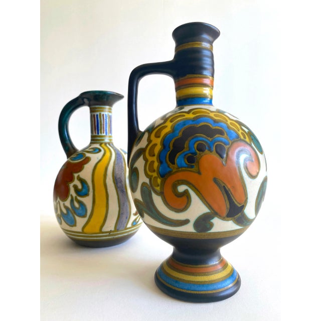 This set of two rare vintage 1920's Gouda Holland Art Nouveau hand painted floral signed Dutch art pottery handled ewer...