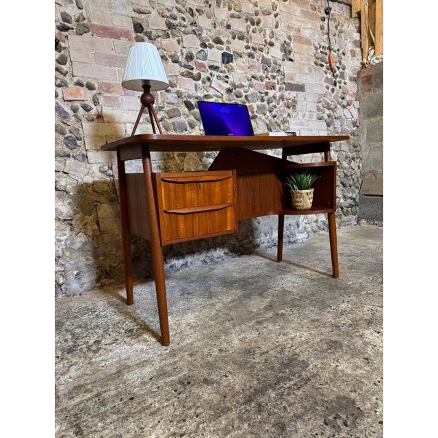 Absolutely stunning example of a small Danish teak floating top desk. Designed by Gunner Nielsen Produced by Tibergaard...