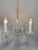 This lovely 5-arm chandelier features elegant Venetian-style scrolls and beautifully detailed crystal accents. Its...