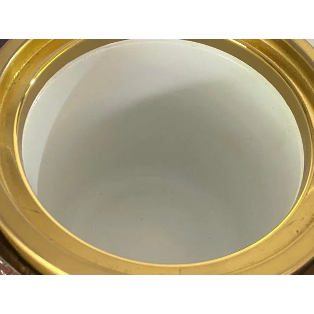 This ice bucket is in Leather, plastic and gilt metal. This has been made in Switzerland Circa 1970. Red-Purple and gold...