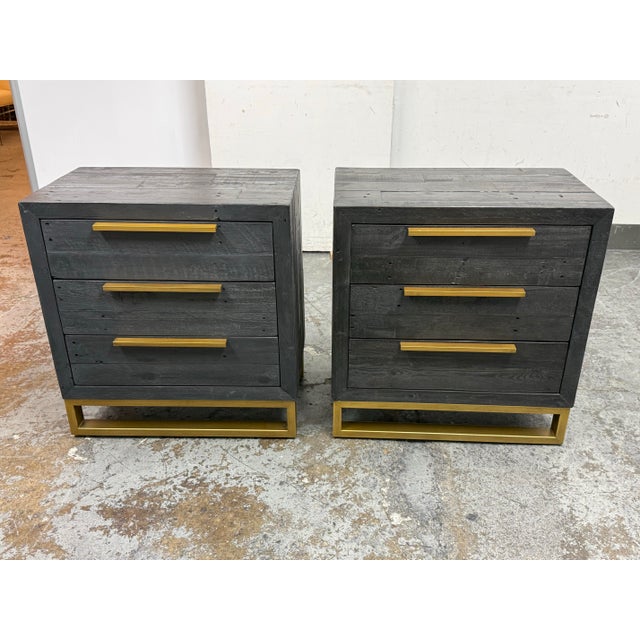 Design Plus Gallery presents a Pair of Elle Brass Leg Reclaimed Wood Nightstands from Zin Home. A rustic modern bedside...