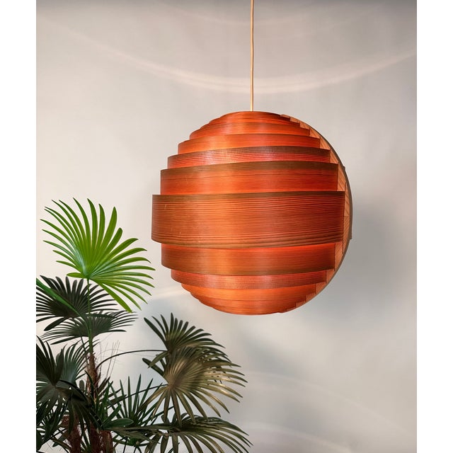 This large spherical modernist pendant light was designed by Hans-Agne Jakobsson for Ellyset and was handcrafted in Sweden...