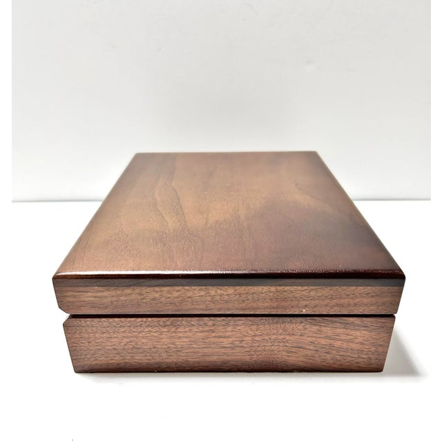 A beautifully handcrafted solid walnut storage box with rich grain variation and clean, minimal lines. Lined in black...