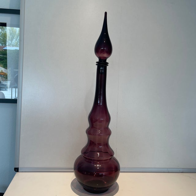 Purple decanter with genie bottle feel. From the 1960s.