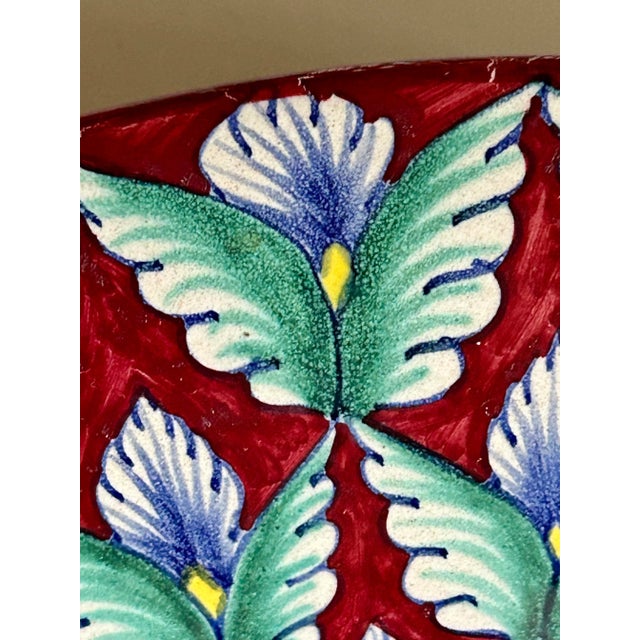 Extremely unusual Italian Deruta hand painted ceramic shallow 12” dish. The deep rose background is covered with a...